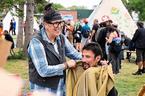 Mike Sudoma/Free Press
Jamie Goulet of Clan Mothers Healing Village shares a moment with participant Leroy Plett after trimming up his hair and beard as part of the Gizhe Waa Ti-Sii-Win Service Expo Friday afternoon
Sept 13, 2024
