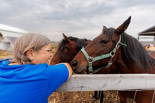 MIKE DEAL / FREE PRESS
Owner-manager Louise May chats with horses Mandy (right) and Charlie (background). 
Aurora Farm in St. Norbert is celebrating its 20th anniversary this weekend by inviting the public to visit and enjoy tours of the farm and various workshops.
They run the 160-acre farm&#x2019;s operations, which include producing 10,000 bars of goat milk soap a year; running a summer camp so youth can learn about farming; hosting a diversity of programs to facilitate the building of traditional agrarian skills; and offering baby goat yoga, which attracts thousands of visitors annually.
240913 - Friday, September 13, 2024.