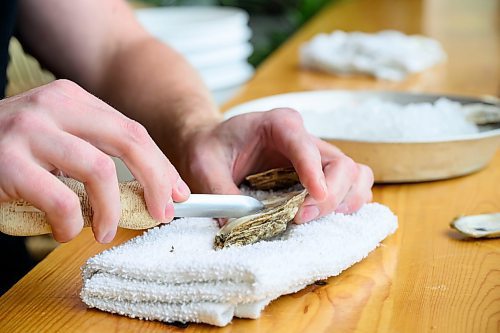 Mike Sudoma/Free Press
Aaron Crawford of RAW Bar shucks oysters at Kilter Brewing Friday afternoon
Sept 13, 2024
