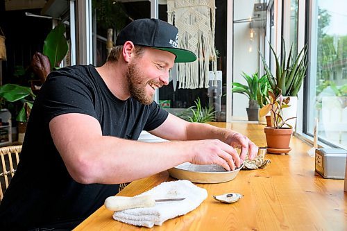 Mike Sudoma/Free Press
Aaron Crawford of RAW Bar  laughs while he shucks oysters at Kilter Brewing Friday afternoon
Sept 13, 2024
