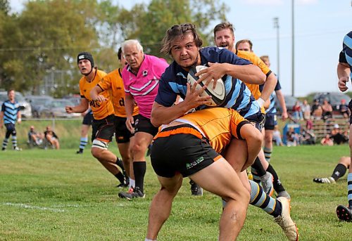 Brandon Barbarians Richard Pierreroy is tackled by a Manitoba Wombat during their Rugby Manitoba men's Division 2 semifinal at John Reilly Field on Saturday. (Thomas Friesen/The Brandon Sun)