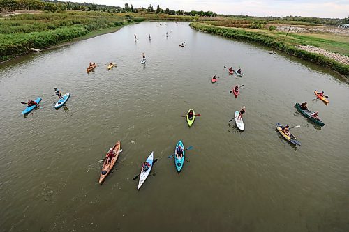 Canoes, kayaks and paddleboards sail down the Assiniboine River from the Riverbank Discovery Centre as part of Paddlefest on Saturday evening. (Colin Slark/The Brandon Sun)