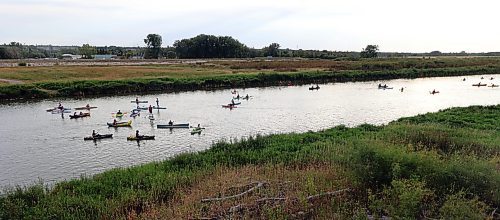 Canoes, kayaks and paddleboards sail down the Assiniboine River from the Riverbank Discovery Centre as part of Paddlefest on Saturday evening. (Colin Slark/The Brandon Sun)