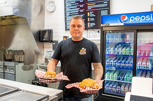 BROOK JONES / FREE PRESS
Winnipegger Eric Saniuk, 30, owner of Blazing Chicken Shack, serves a Queen City Buffalo Sando and a Music City Nashville Sando at his restuarant at 392 Graham Ave., in Winnipeg, Man., Monday, Sept. 16, 2024. Saniuk hosted a grand opening Friday, Sept. 13, 2024.