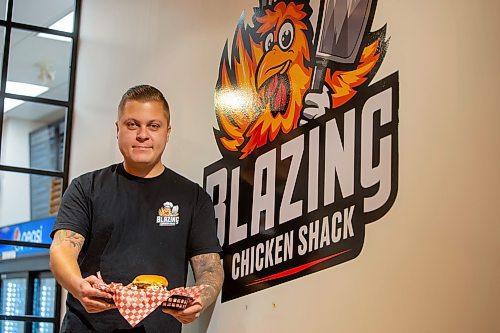 BROOK JONES / FREE PRESS
Thirty-year-old Eric Saniuk who is the owner of Blazing Chicken Shack is pictured holding a Music City Nashville Sando at his restaurant at 392 Graham Ave., in Winnipeg, Man., Monday, Sept. 16, 2024. Saniuk hosted a grand opening Friday, Sept. 13, 2024.