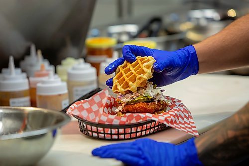 BROOK JONES / FREE PRESS
Thirty-year-old Eric Saniuk who is the owner of Blazing Chicken Shack is pictured preparing a Hot Honey Wafflewich at his restaurant at 392 Graham Ave., in Winnipeg, Man., Monday, Sept. 16, 2024. Saniuk hosted a grand opening Friday, Sept. 13, 2024.