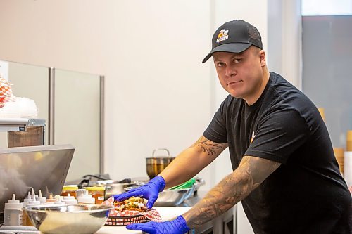 BROOK JONES / FREE PRESS
Thirty-year-old Eric Saniuk who is the owner of Blazing Chicken Shack is pictured preparing a Hot Honey Wafflewich at his restaurant at 392 Graham Ave., in Winnipeg, Man., Monday, Sept. 16, 2024. Saniuk hosted a grand opening Friday, Sept. 13, 2024.