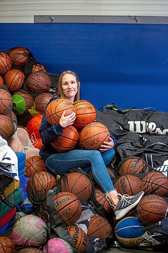 BROOK JONES / FREE PRESS
Thirty-six-year-old Carrissa Reyes is a volunteer coach with the 7-8 coed South Winnipeg Trailblazers basketball team that plays in the Winnipeg Minor Basketball Association community league. Reyes who is also a volunteer director on the board of the WMBA is pictured holding a number of basketballs as she sits on a pile of basketballs inside the basketball storage room at the South Winnipeg Community Centre Waverley Site in Winnipeg, Man., Monday, Sept. 16, 2024.