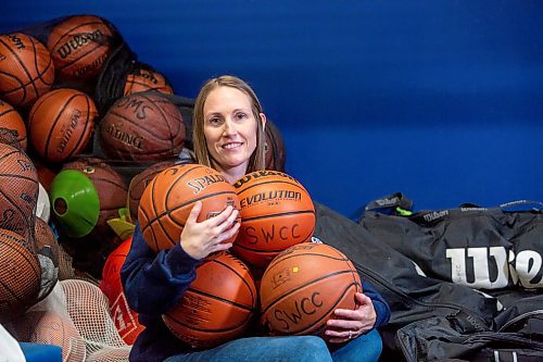 BROOK JONES / FREE PRESS
Thirty-six-year-old Carrissa Reyes is a volunteer coach with the 7-8 coed South Winnipeg Trailblazers basketball team that plays in the Winnipeg Minor Basketball Association community league. Reyes who is also a volunteer director on the board of the WMBA is pictured holding a number of basketballs as she sits on a pile of basketballs inside the basketball storage room at the South Winnipeg Community Centre Waverley Site in Winnipeg, Man., Monday, Sept. 16, 2024.