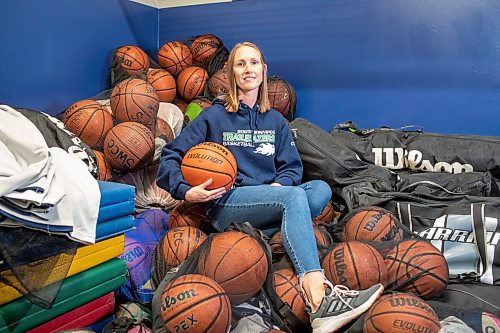 BROOK JONES / FREE PRESS
Thirty-six-year-old Carrissa Reyes is a volunteer coach with the 7-8 coed South Winnipeg Trailblazers basketball team that plays in the Winnipeg Minor Basketball Association community league. Reyes who is also a volunteer director on the board of the WMBA is pictured holding a basketball as she sits on a pile of basketballs inside the basketball storage room at the South Winnipeg Community Centre Waverley Site in Winnipeg, Man., Monday, Sept. 16, 2024.