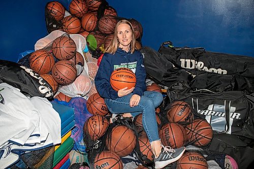 BROOK JONES / FREE PRESS
Thirty-six-year-old Carrissa Reyes is a volunteer coach with the 7-8 coed South Winnipeg Trailblazers basketball team that plays in the Winnipeg Minor Basketball Association community league. Reyes who is also a volunteer director on the board of the WMBA is pictured holding a basketball as she sits on a pile of basketballs inside the basketball storage room at the South Winnipeg Community Centre Waverley Site in Winnipeg, Man., Monday, Sept. 16, 2024.