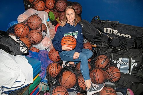 BROOK JONES / FREE PRESS
Thirty-six-year-old Carrissa Reyes is a volunteer coach with the 7-8 coed South Winnipeg Trailblazers basketball team that plays in the Winnipeg Minor Basketball Association community league. Reyes who is also a volunteer director on the board of the WMBA is pictured holding a number of basketballs as she sits on a pile of basketballs inside the basketball storage room at the South Winnipeg Community Centre Waverley Site in Winnipeg, Man., Monday, Sept. 16, 2024.