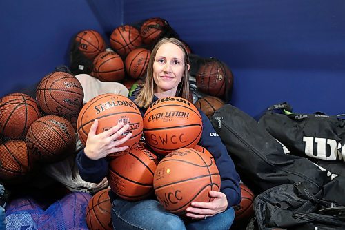 BROOK JONES / FREE PRESS
Thirty-six-year-old Carrissa Reyes is a volunteer coach with the 7-8 coed South Winnipeg Trailblazers basketball team that plays in the Winnipeg Minor Basketball Association community league. Reyes who is also a volunteer director on the board of the WMBA is pictured holding a basketball as she sits on a pile of basketballs inside the basketball storage room at the South Winnipeg Community Centre Waverley Site in Winnipeg, Man., Monday, Sept. 16, 2024.