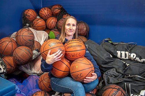 BROOK JONES / FREE PRESS
Thirty-six-year-old Carrissa Reyes is a volunteer coach with the 7-8 coed South Winnipeg Trailblazers basketball team that plays in the Winnipeg Minor Basketball Association community league. Reyes who is also a volunteer director on the board of the WMBA is pictured holding a basketball as she sits on a pile of basketballs inside the basketball storage room at the South Winnipeg Community Centre Waverley Site in Winnipeg, Man., Monday, Sept. 16, 2024.