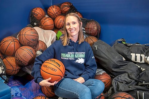 BROOK JONES / FREE PRESS
Thirty-six-year-old Carrissa Reyes is a volunteer coach with the 7-8 coed South Winnipeg Trailblazers basketball team that plays in the Winnipeg Minor Basketball Association community league. Reyes who is also a volunteer director on the board of the WMBA is pictured holding a basketball as she sits on a pile of basketballs inside the basketball storage room at the South Winnipeg Community Centre Waverley Site in Winnipeg, Man., Monday, Sept. 16, 2024.