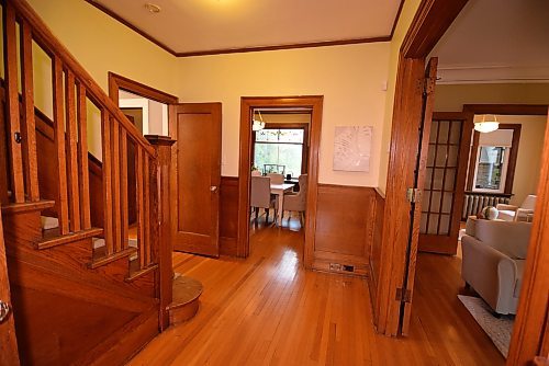 Todd Lewys / Winnipeg Free Press

Stepping into the home reveals a landing area with a grand staircase that's surrounded by gorgeous woodwork on every side.