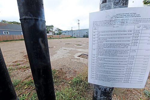 A City of Brandon notice of public auction is affixed to the remains of a sign outside the former Esso station at 402 Rosser Ave. on Wednesday afternoon. The tax arrears auction is slated to take place on Oct. 17. (Matt Goerzen/The Brandon Sun)