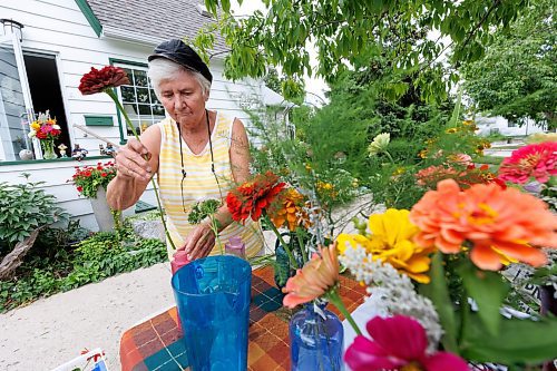 MIKE DEAL / FREE PRESS
Erika Neumann puts the finishing touches on some flower arrangements that will be sold to raise money for Harvest Manitoba.
Three generations of a family in Wolseley are using their love of flowers to brighten the day for others by selling the flowers grown in their yard to raise money for Harvest Manitoba.
Reporter: Janine LeGal
240906 - Friday, September 06, 2024.