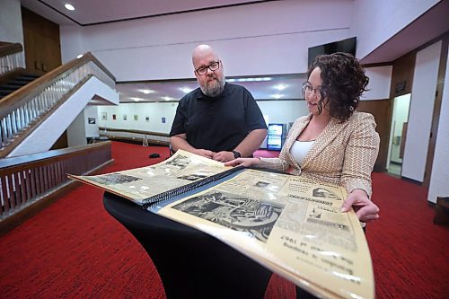 In the foyer of the Western Manitoba Centennial Auditorium, board chair Shaun Cameron and facility general manager Kaitlyn Mitchell look through a laminated bound copy of a special keepsake on Wednesday afternoon that was published by The Brandon Sun on Sept. 29, 1969 in anticipation of the Oct. 1 opening day of the WMCA. (Matt Goerzen/The Brandon Sun)