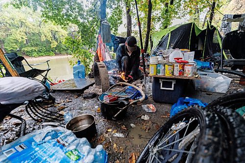 MIKE DEAL / FREE PRESS
Terry trends to a fire while trying to dry off clothing in his campsite at Fort Rouge park Wednesday afternoon.
Reporter: Katrina Clarke
240918 - Wednesday, September 18, 2024.