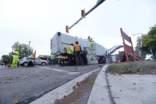 A Manitoba road crew begins tearing up 18th Street at the Rosser Avenue intersection on Wednesday afternoon as reconstruction of one of Brandon's main thoroughfares begins, following Wab Kinew's announcement of $9.7 million to resurface the street between Rosser and Aberdeen avenues on Sept. 3. (Matt Goerzen/The Brandon Sun)