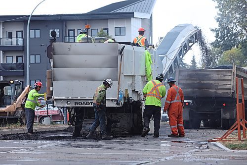 A Manitoba road crew begins tearing up 18th Street at the Rosser Avenue intersection on Wednesday afternoon as reconstruction of one of Brandon's main thoroughfares begins, following Wab Kinew's announcement of $9.7 million to resurface the street between Rosser and Aberdeen avenues on Sept. 3. (Matt Goerzen/The Brandon Sun)