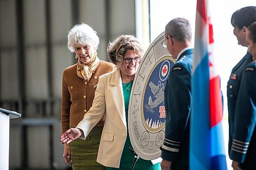 MIKAELA MACKENZIE / WINNIPEG FREE PRESS

Phyllis Clark, chair of the Royal Canadian Mint's board of directors (left), Marie Lemay, president and CEO of the Royal Canadian Mint, and lieutenant-general Eric Kenny, commander of the Royal Canadian Air Force, reveal a special two&#x2011;dollar circulation coin commemorating the 100th anniversary of the Royal Canadian Air Force on Wednesday, Sept. 18, 2024.

Standup.
Winnipeg Free Press 2024