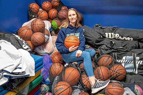 BROOK JONES / FREE PRESS
Thirty-six-year-old Carrissa Reyes is a volunteer coach with the 7-8 coed South Winnipeg Trailblazers basketball team that plays in the Winnipeg Minor Basketball Association community league. Reyes who is also a volunteer director on the board of the WMBA is pictured holding a basketball as she sits on a pile of basketballs inside the basketball storage room at the South Winnipeg Community Centre Waverley Site in Winnipeg, Man., Monday, Sept. 16, 2024.