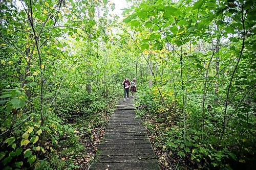 MIKAELA MACKENZIE / WINNIPEG FREE PRESS

Lockport School grade nine students Kasey Forman (left) and Sam Caslake walk the trail at the grand opening of Lord Selkirk School Division&#x573; Albert Beach Trail field trip site on Thursday, Sept. 19, 2024.

For Maggie story.
Winnipeg Free Press 2024