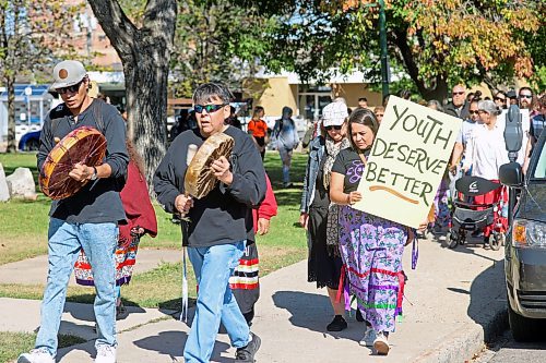 Lisa Noctor holds a sign as participants walk out of Princess Park on Friday to raise awareness about the sexual exploitation of children. The event, called the Grandmother's Walk, is held each year in Brandon. (Connor McDowell/Brandon Sun)