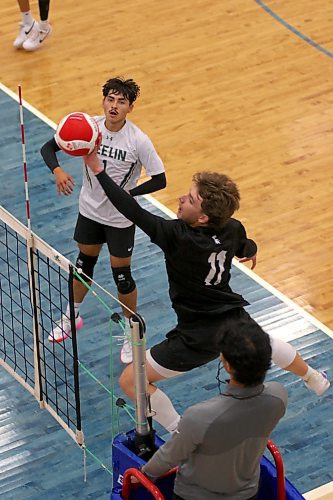 Neelin Spartans left side Lucas Gamache stretches to tip a ball left handed while libero Kingston Thomas covers during the BU varsity boys' volleyball tournament. (Thomas Friesen/The Brandon Sun)