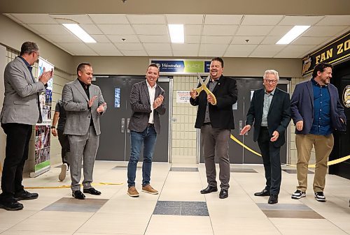 Municipal and Northern Relations Minister Ian Bushie cuts the ribbon for the unveiling of the newly renovated Westoba Place arena on Friday evening as other dignitaries look on. From left: Keystone Centre board chair Bruce Luebke, Brandon Wheat Kings owner Jared Jacobson, Provincial Exhibition president Clint Swain, Bushie, Deputy Mayor Glen Parker and Sport, Culture, Heritage and Tourism Minister Glen Simard. (Tim Smith/The Brandon Sun)