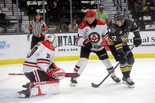 Marcus Nguyen of the Brandon Wheat Kings watches a shot on netminder Jackson Unger of the Moose Jaw Warriors during the first period of the Wheaties WHL home opener at Westoba Place on Friday evening. (Tim Smith/The Brandon Sun)