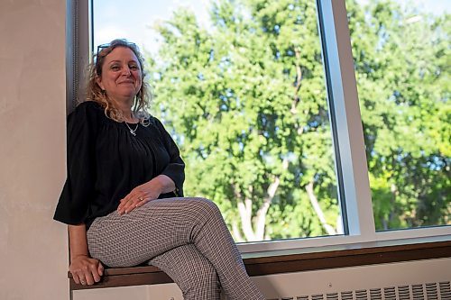 BROOK JONES / FREE PRESS
The event space at Congregation Shaarey Zedek has undergone renovations which include the installation of windows that face the Assiniboine River. Rena Secter Elbaze who is the executive director of Congregation Shaarey Zedek is pictured sitting on the windowsill of one of the newly installed windows during the evening of Thursday, Sept. 19, 2024.