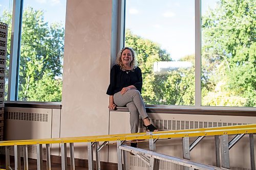 BROOK JONES / FREE PRESS
The event space at Congregation Shaarey Zedek has undergone renovations which include the installation of windows that face the Assiniboine River. Rena Secter Elbaze who is the executive director of Congregation Shaarey Zedek is pictured sitting on the windowsill of one of the newly installed windows during the evening of Thursday, Sept. 19, 2024.