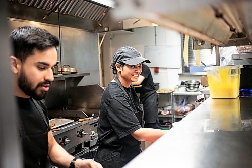 MIKAELA MACKENZIE / WINNIPEG FREE PRESS

Aashank Kalia (left) and Sudha Sharma whip up orders in the kitchen at the Roasted Nomad on Friday, Sept. 20, 2024. 

For Eva story.
Winnipeg Free Press 2024