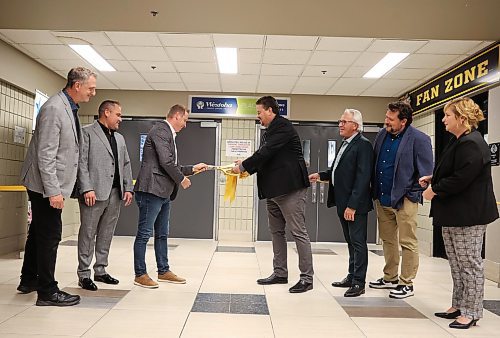 20092024
Ian Bushie, Minister of Municipal and Northern Relations as well as Minister of Indigenous Economic Development, cuts the ribbon for the unveiling of the newly renovated Westoba Place arena on Friday evening as other dignitaries look on. 
(Tim Smith/The Brandon Sun)