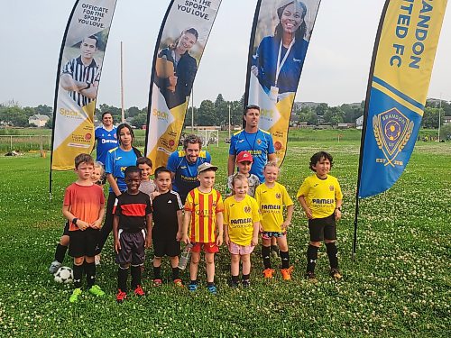 Brandon United Football Club president Rodrigo Riquelme (Back), some volunteer trainers and U-7 kids of the club. (Abiola Odutola/The Brandon Sun)