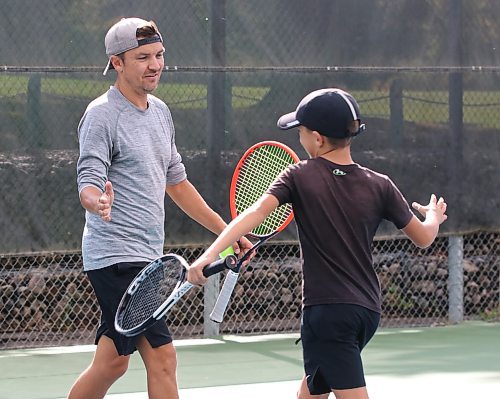 Nick Onischuk and his eight-year-old son Beckett celebrate a point against the duo of 80-year-old Ramjit Mann and Chad McNish during the Wheat City Tennis Club's annual Pie Tournament on Saturday afternoon. The father-and-son duo won the game in straight sets (6-4, 7-5) to win the West Division. Meanwhile, Samantha Lee and Anthony Lee won the East Division against Gilbert Lee (Samantha's father) and Kit Harrison, Jim Ross and Bryan Schettler beat brothers Ray and Francis Cancade to win the South Division, and Brian Dorn and Craig Dedrick &#x2014; who stood in for Andrew Arksey &#x2014; topped beat Stacy May and Kelly Bessette in three sets under the lights to win the North Division. Each of the winners received a pie. (Perry Bergson/The Brandon Sun)
Sept. 21, 2024