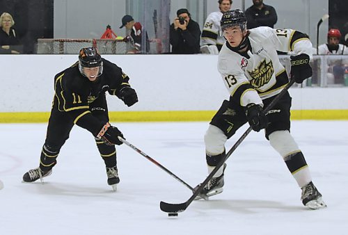 Brandon Wheat Kings forward Roger McQueen, shown during training camp carrying the puck against defenceman Dylan Ronald (11), was named the Western Hockey League's player of the week after he scored four goals and added two assists on the weekend. He is the team's tallest player at six-foot-five. (Perry Bergson/The Brandon Sun)