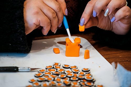 JOHN WOODS / FREE PRESS
Christine Brouzes, an artist who makes clay pins by hand to mark Orange Shirt Day, creates some her tiny creations in her home Monday, September 23, 2024. 

Reporter: malak