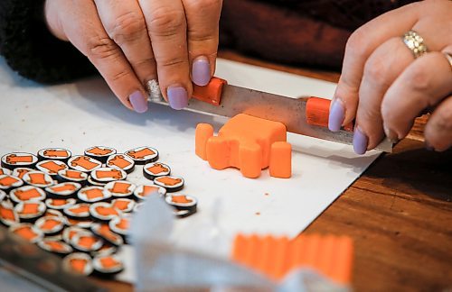 JOHN WOODS / FREE PRESS
Christine Brouzes, an artist who makes clay pins by hand to mark Orange Shirt Day, creates some her tiny creations in her home Monday, September 23, 2024. 

Reporter: malak