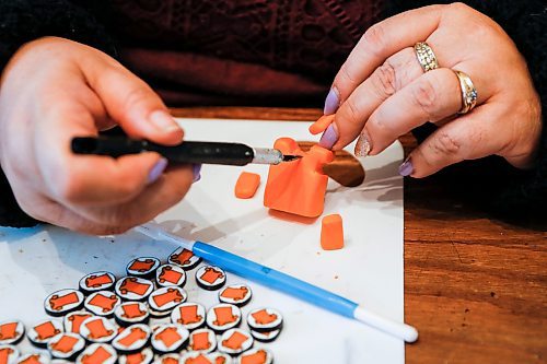 JOHN WOODS / FREE PRESS
Christine Brouzes, an artist who makes clay pins by hand to mark Orange Shirt Day, creates some her tiny creations in her home Monday, September 23, 2024. 

Reporter: malak