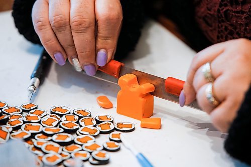 JOHN WOODS / FREE PRESS
Christine Brouzes, an artist who makes clay pins by hand to mark Orange Shirt Day, creates some her tiny creations in her home Monday, September 23, 2024. 

Reporter: malak