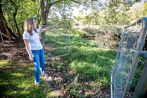 MIKAELA MACKENZIE / WINNIPEG FREE PRESS
	
Cat Macaulay Gauthier points out piles of trees that were recently taken down by the developer at Lemay Forest on Sept. 24, 2024. 

For Joyane story.
Winnipeg Free Press 2024