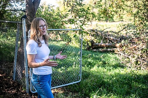 MIKAELA MACKENZIE / WINNIPEG FREE PRESS
	
Cat Macaulay Gauthier points out piles of trees that were recently taken down by the developer at Lemay Forest on Sept. 24, 2024. 

For Joyane story.
Winnipeg Free Press 2024