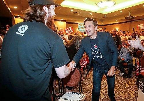 Conservative Leader Pierre Poilievre greets one of hundreds of people that filled a conference room at he Canada Inns Club Regent Casino Hotel on Sunday for an Axe The Tax rally. (John Woods/Winnipeg Free Press)