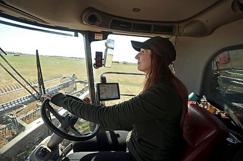 Farmer Angela Charlton operates a combine harvesting canola during the annual fundraiser. (Tim Smith/The Brandon Sun) 