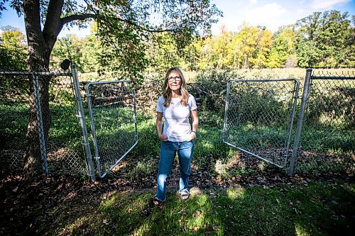 MIKAELA MACKENZIE / WINNIPEG FREE PRESS
	
Cat Macaulay Gauthier with piles of trees that were recently taken down by the developer at Lemay Forest on Sept. 24, 2024. 

For Joyane story.
Winnipeg Free Press 2024