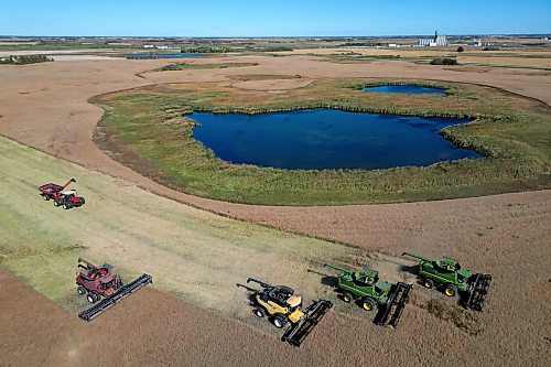 05092024
Four combines and a grain cart work to harvest 125 acres of canola near Oakden, Manitoba as part of the fourth annual Acres for Hamiota community harvest west of Hamiota on a sunny Tuesday. Acres for Hamiota raises money for community projects and organizations and this year all the machinery for the harvest was operated by women to highlight the important role women play in agriculture. The harvest was preceded by a picnic lunch.
Tim Smith/The Brandon Sun)